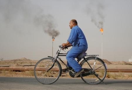 OILING THE WHEELS: A refinery employee rides to work at a Middle East oilfield